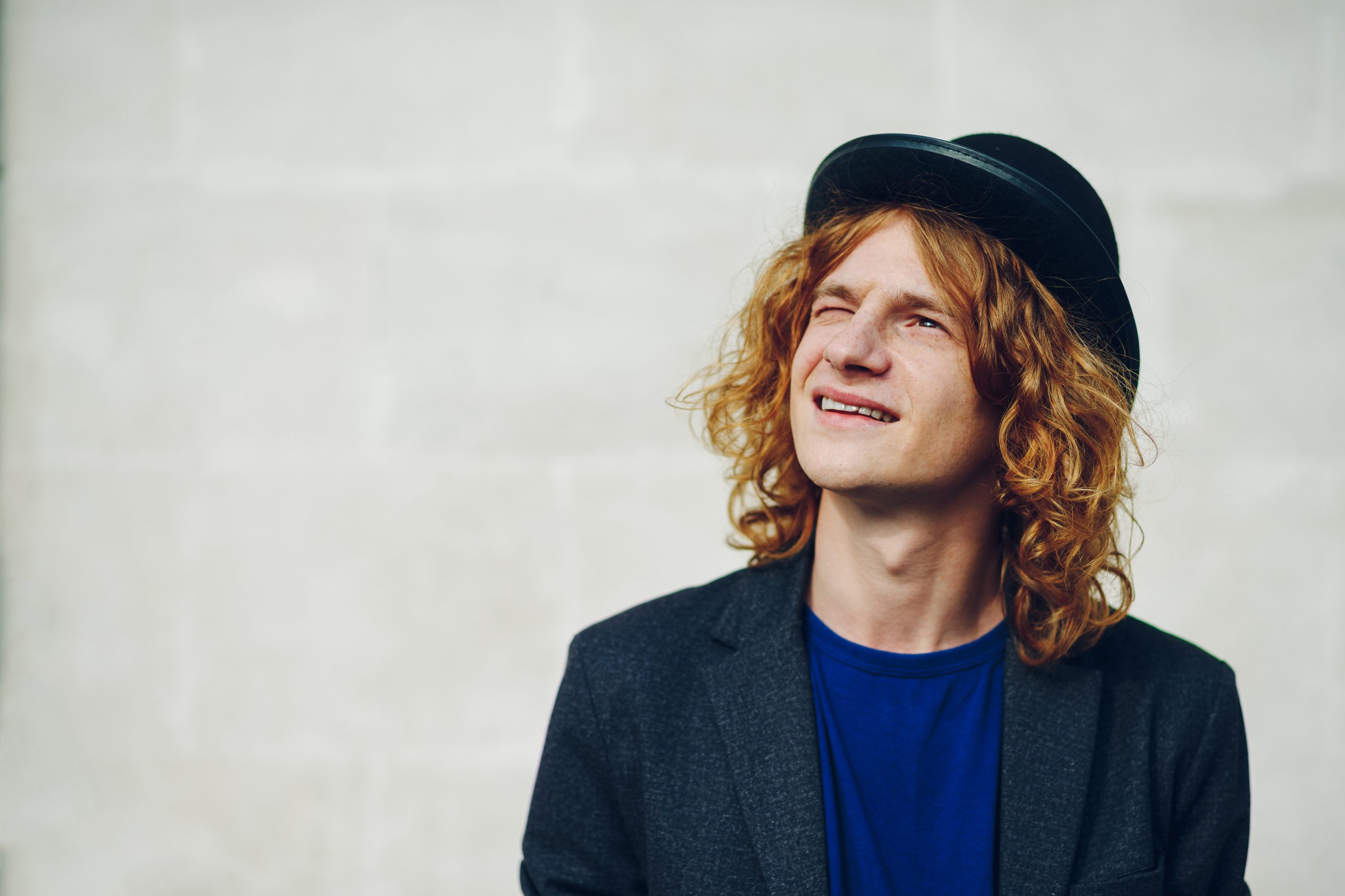 Close-up portrait of young reddish curly man - Forchetti Casting LLC