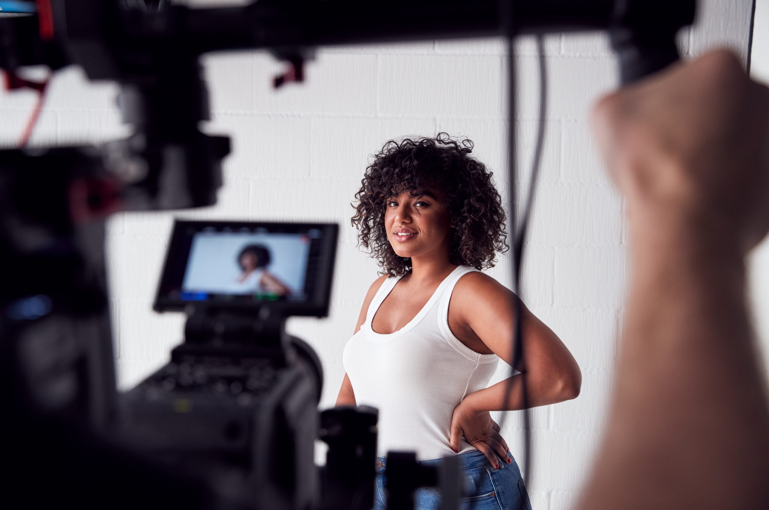 Female Model Posing For Video Camera On Film Set - Forchetti Casting LLC