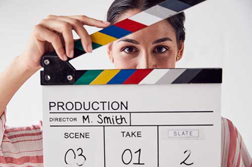 portrait-of-female-videographer-holding-clapper-picture-small